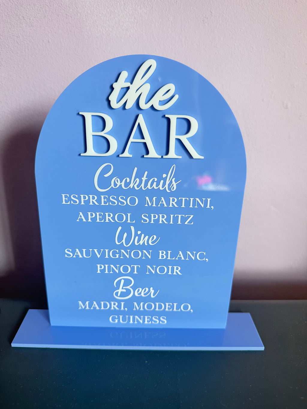 Lavender curved acrylic bar and cocktail menu sign, included in the suite