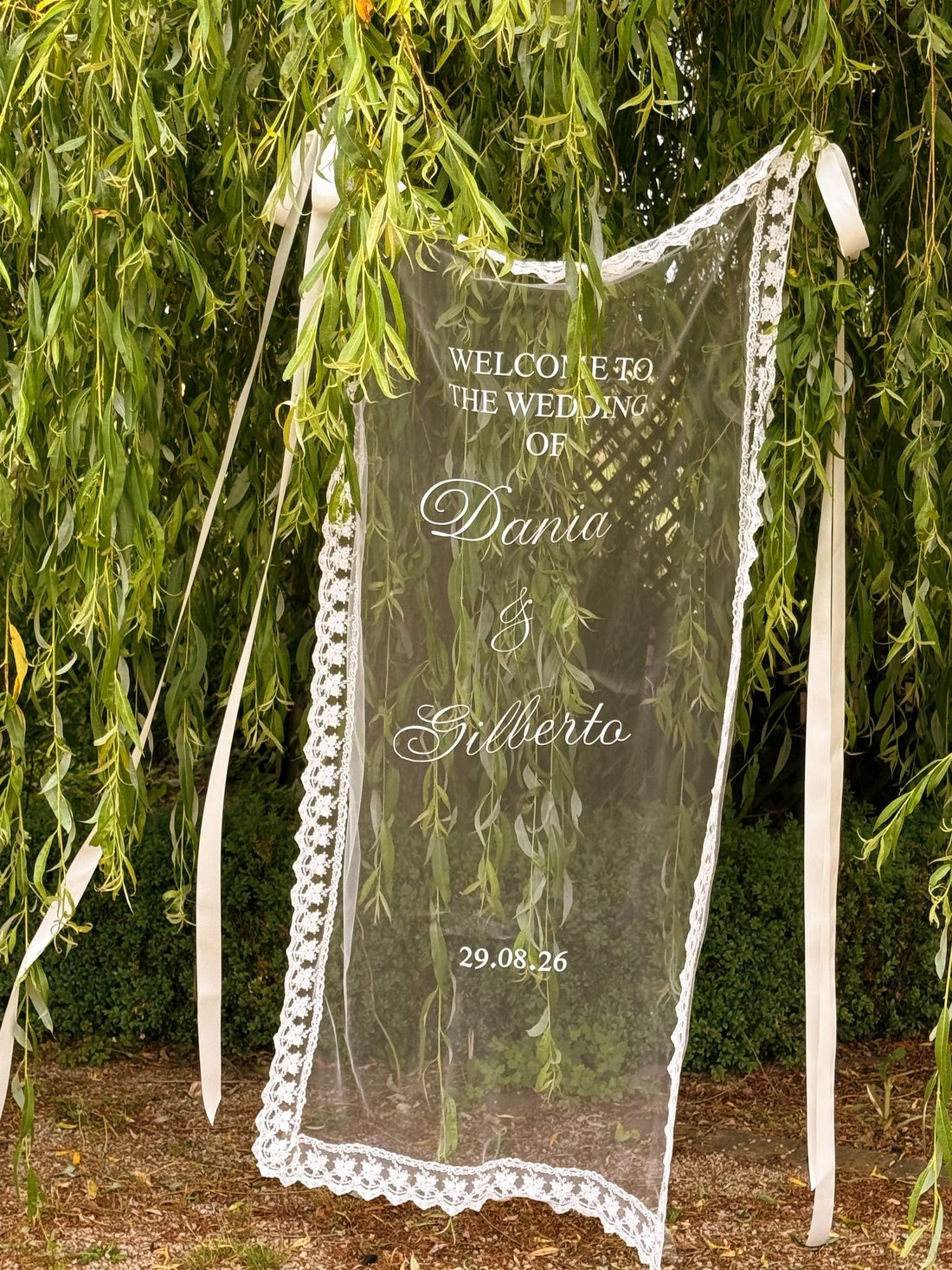 Lace hanging wedding sign styled at the venue